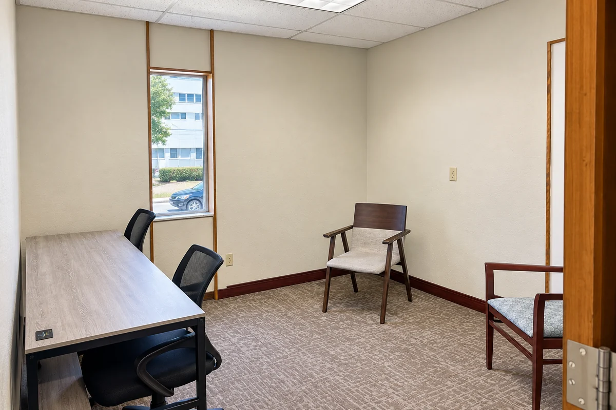private office suite 203 with desk, chairs, and natural light